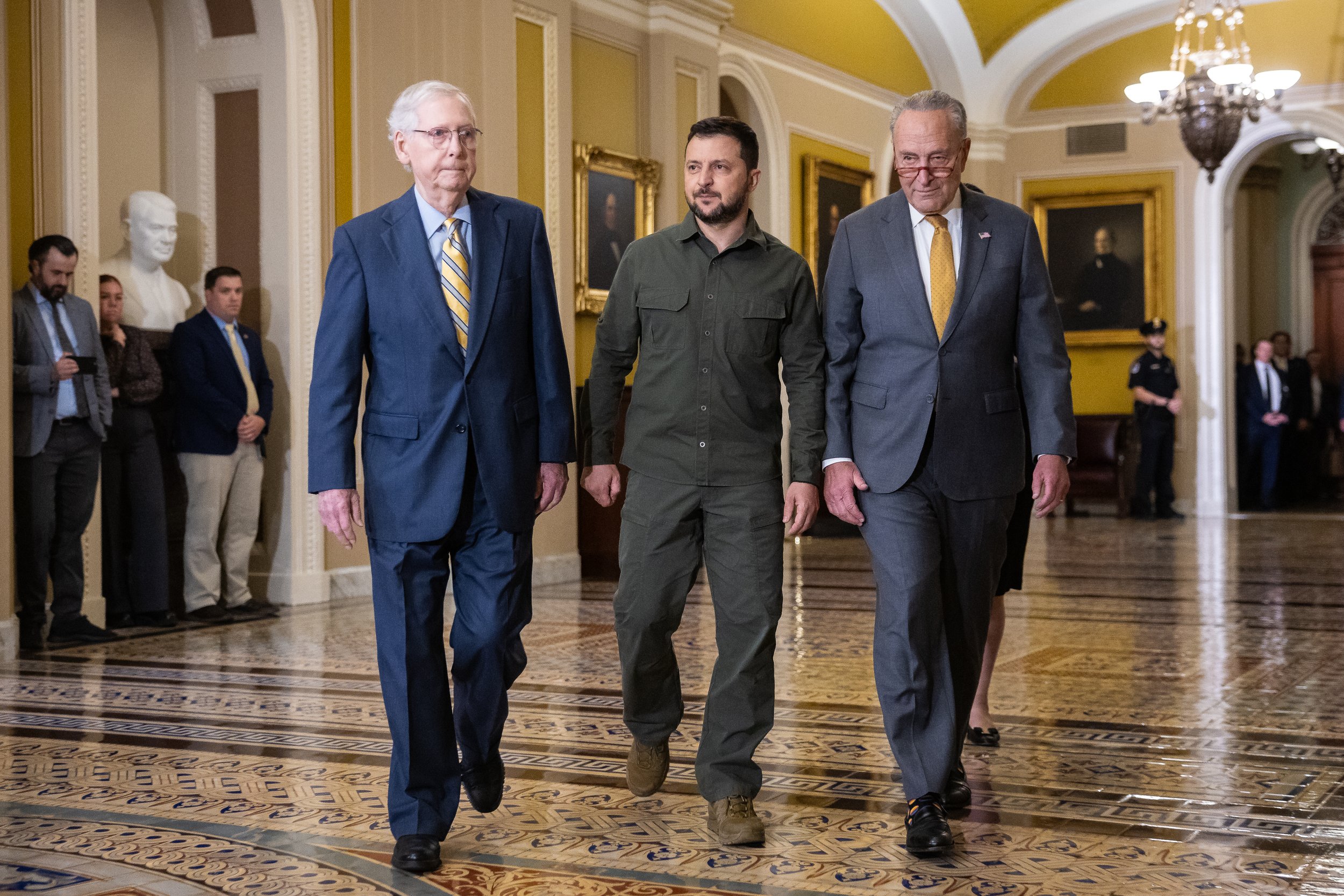  Ukraine President Volodymyr Zelenskyy walks with Senate Minority Leader Mitch McConnell (R-Ky.) and Senate Majority Leader Chuck Schumer (D-N.Y.) as he arrives for a meeting with senators at the U.S. Capitol Sept. 21, 2023. 