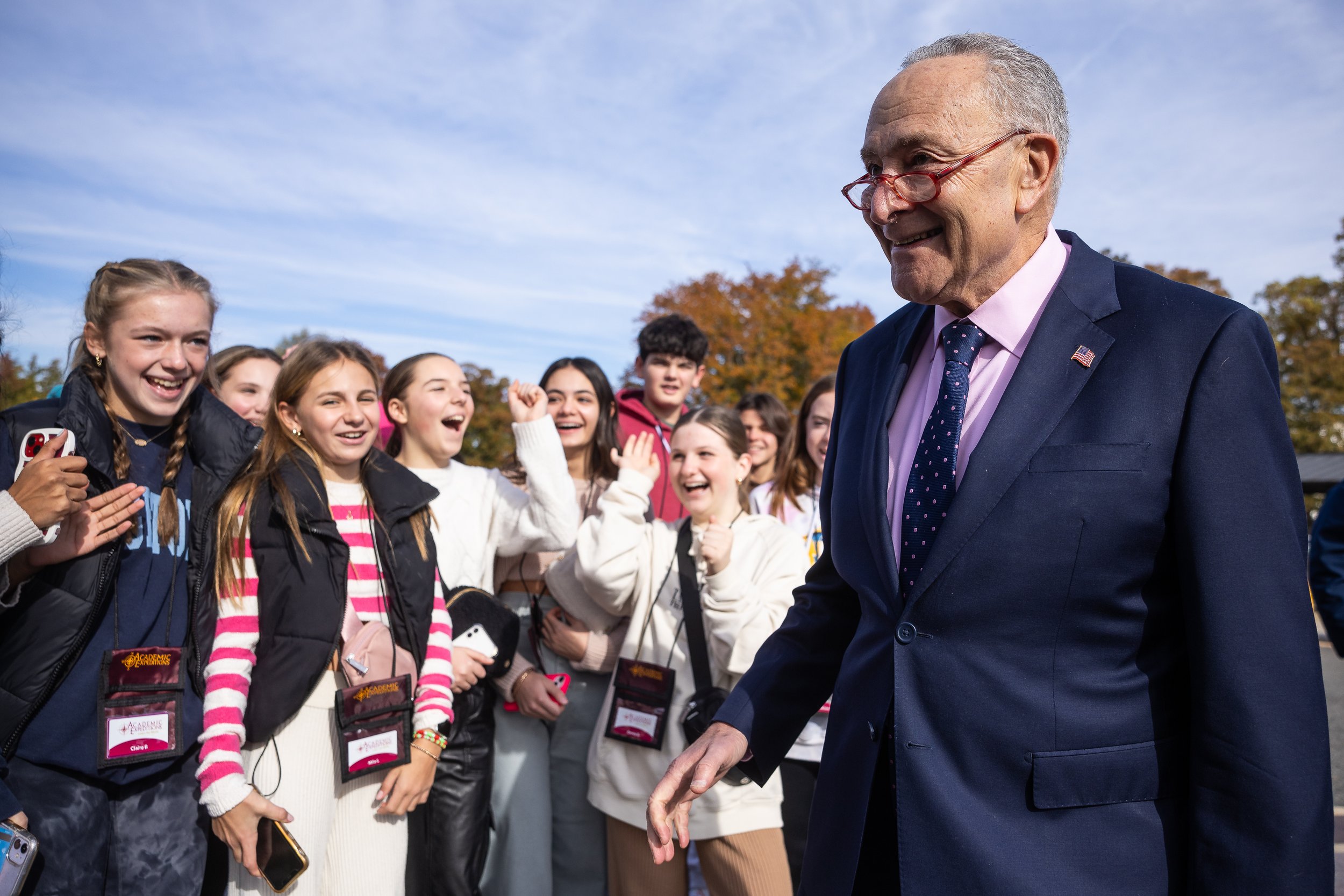 Senate Majority Leader Chuck Schumer (D-N.Y.) stops to greet a group of visiting students as he departs a press conference outside the U.S. Capitol Nov. 15, 2023.