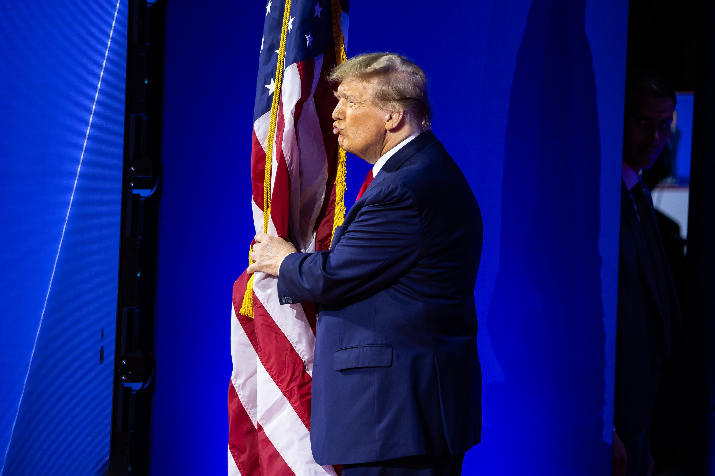  Former President Donald Trump kisses an American flag as he arrives to deliver remarks during the Conservative Political Action Conference (CPAC) at the Gaylord National Resort and Convention Center in National Harbor, Md., Feb. 24, 2024.  