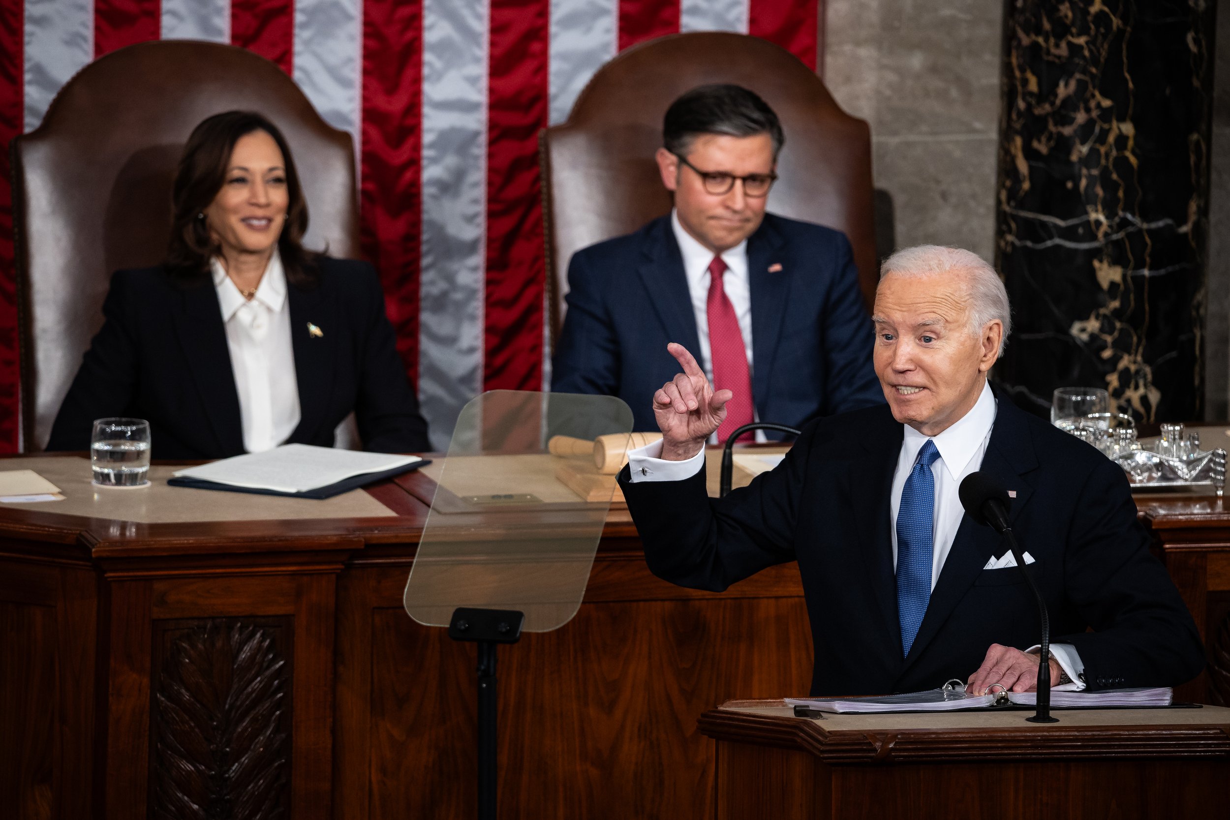  President Joe Biden delivers his State of the Union address as Vice President Kamala Harris and House Speaker Mike Johnson (R-La.) look on in the House chamber at the U.S. Capitol March 7, 2024.  