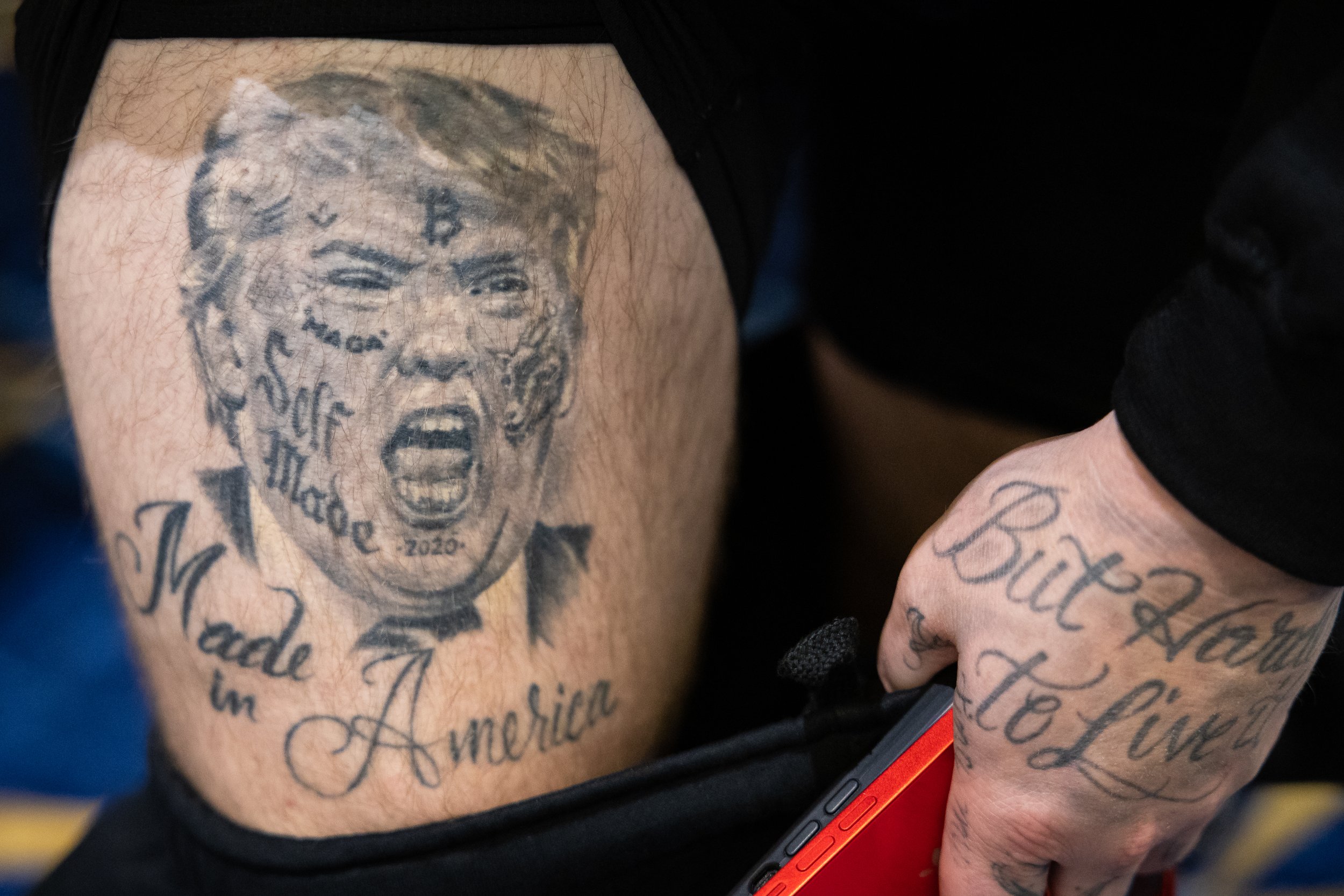  Rapper Forgiato Blow exposes his leg to show off a tattoo depicting former President Donald Trump during the Conservative Political Action Conference (CPAC) at the Gaylord National Resort and Convention Center in National Harbor, Md., March 3, 2023.