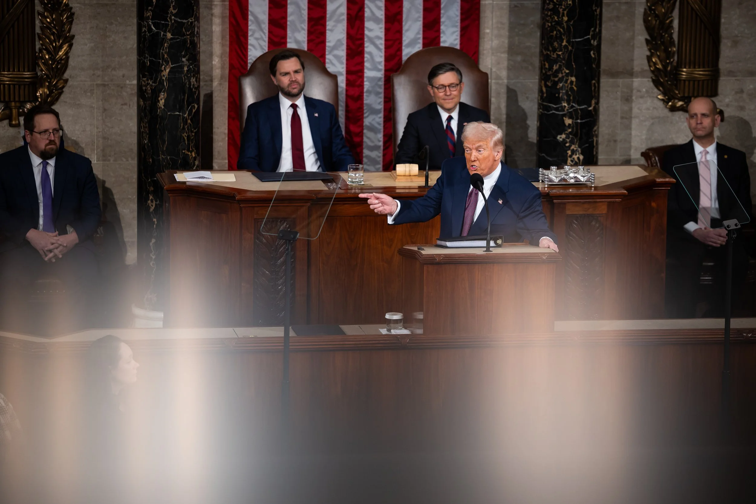  President Donald Trump delivers an address to a joint session of Congress in the House chamber of the U.S. Capitol March 4, 2025. Behind him, Vice President JD Vance and House Speaker Mike Johnson (R-La.) are seen. 