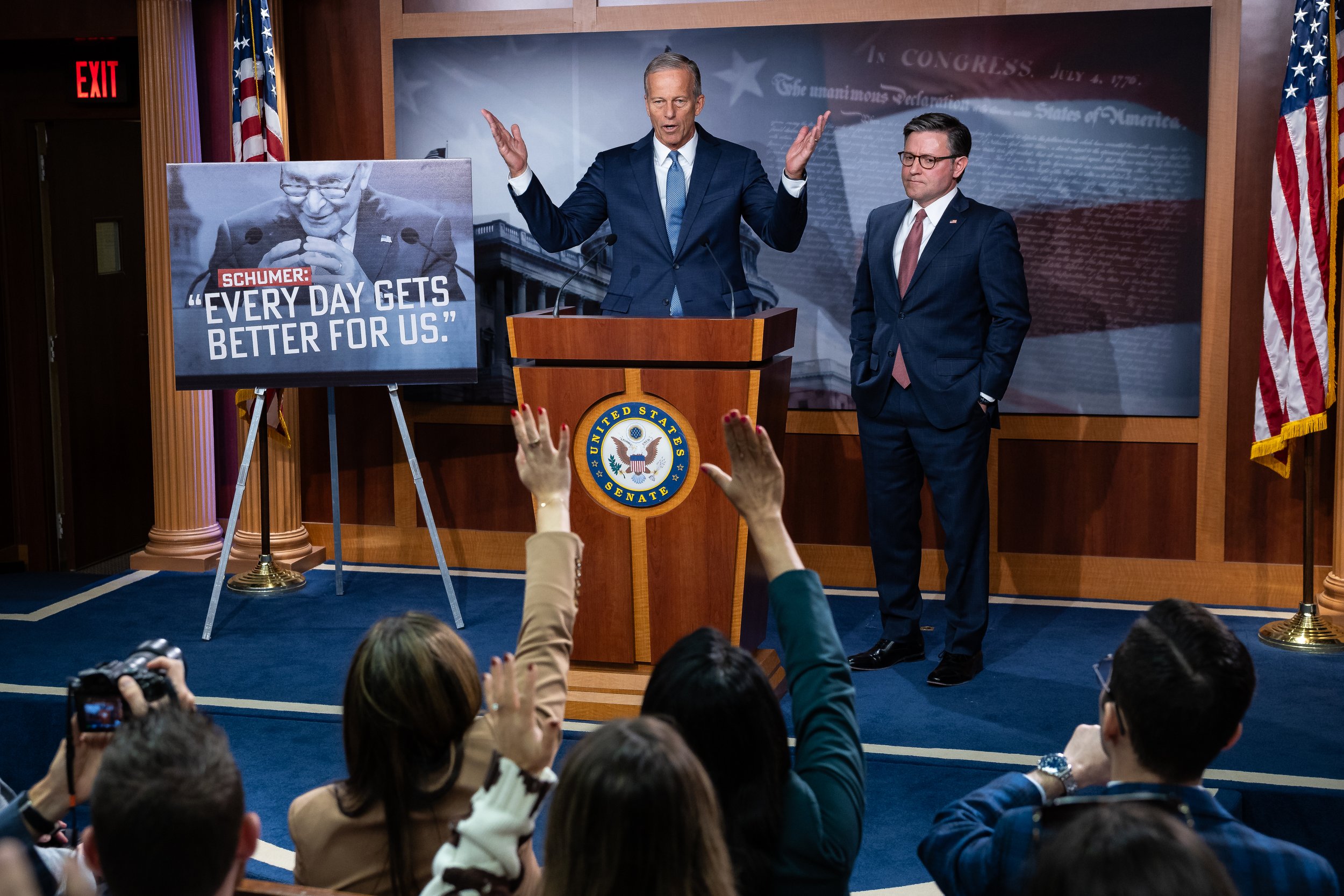  Senate Majority Leader John Thune (R-S.D.) speaks alongside House Speaker Mike Johnson (R-La.) during a press conference at the U.S. Capitol on the 10th day of a government shutdown, Oct. 10, 2025. At left, a sign is displayed with an image of Senat