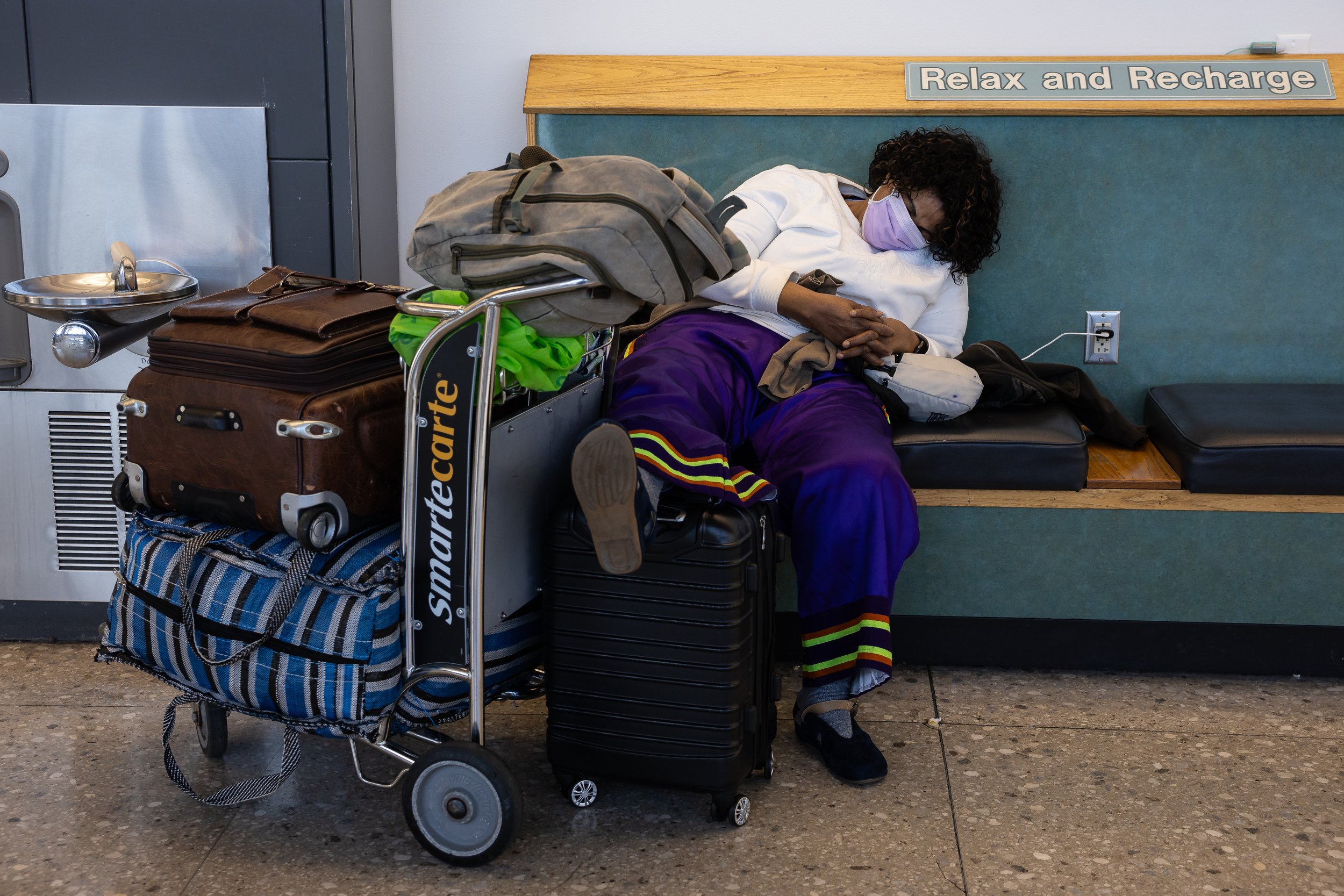  A woman sleeps at Washington Dulles International Airport (IAD) in Dulles, Va. on the 37th day of a government shutdown, Nov. 6, 2025. 