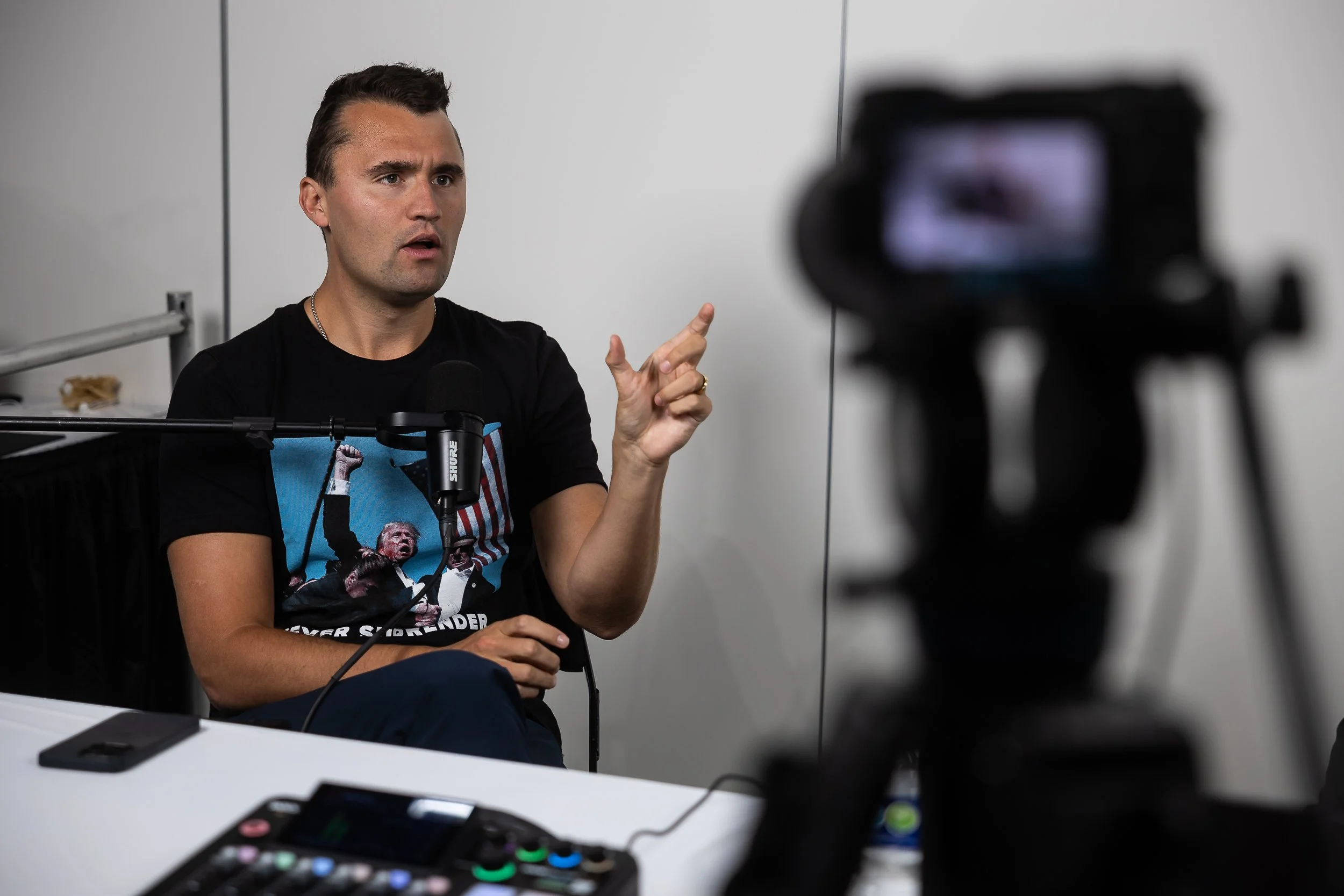  Turning Point USA founder Charlie Kirk wears a shirt featuring a photo of former President Donald Trump in the immediate aftermath of his recent assassination attempt during the third night of the Republican National Convention at Fiserv Forum in Mi