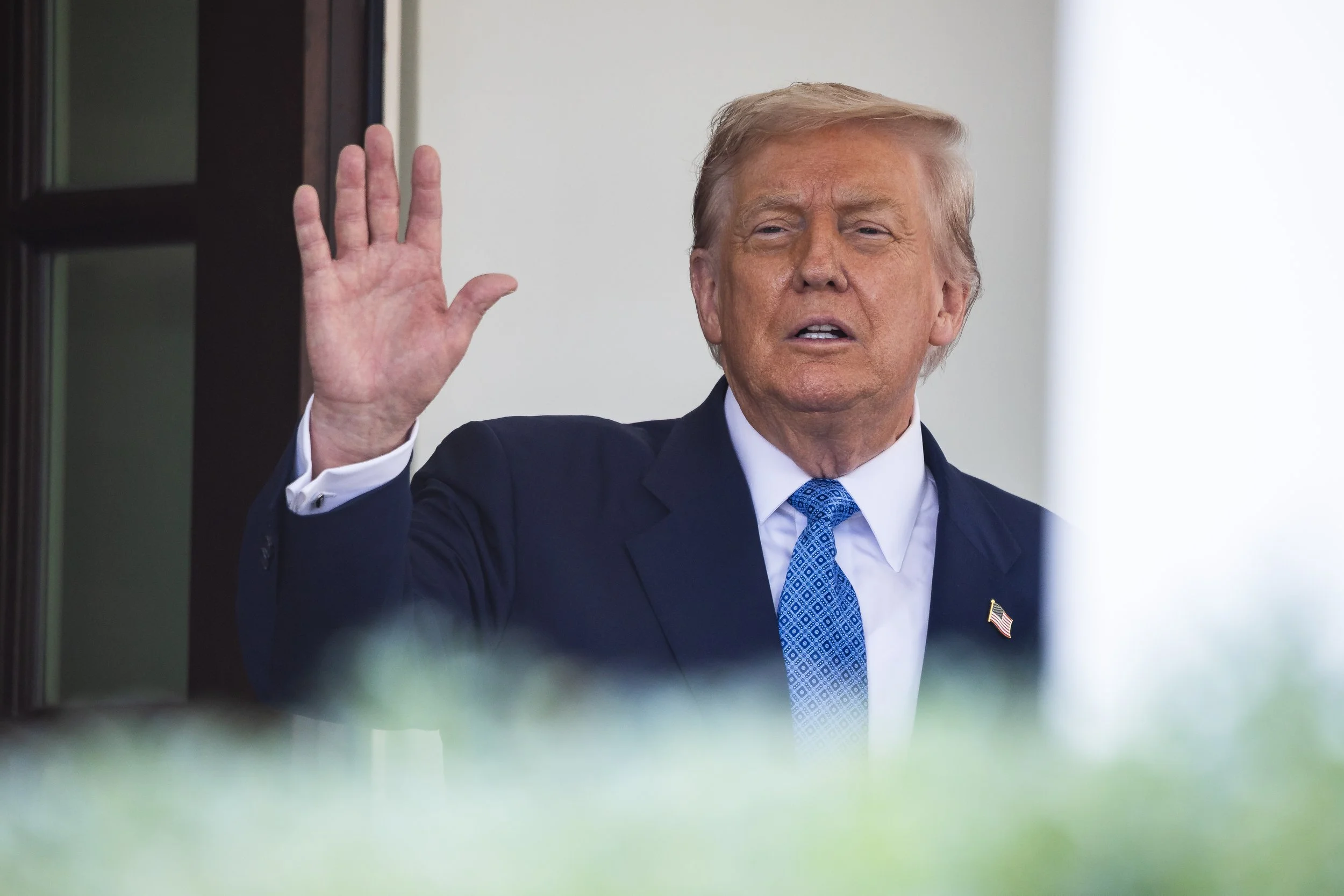 President Donald Trump waves to journalists as he greets Azerbaijan President Ilham Aliyev outside the West Wing of the White House Aug. 8, 2025.  