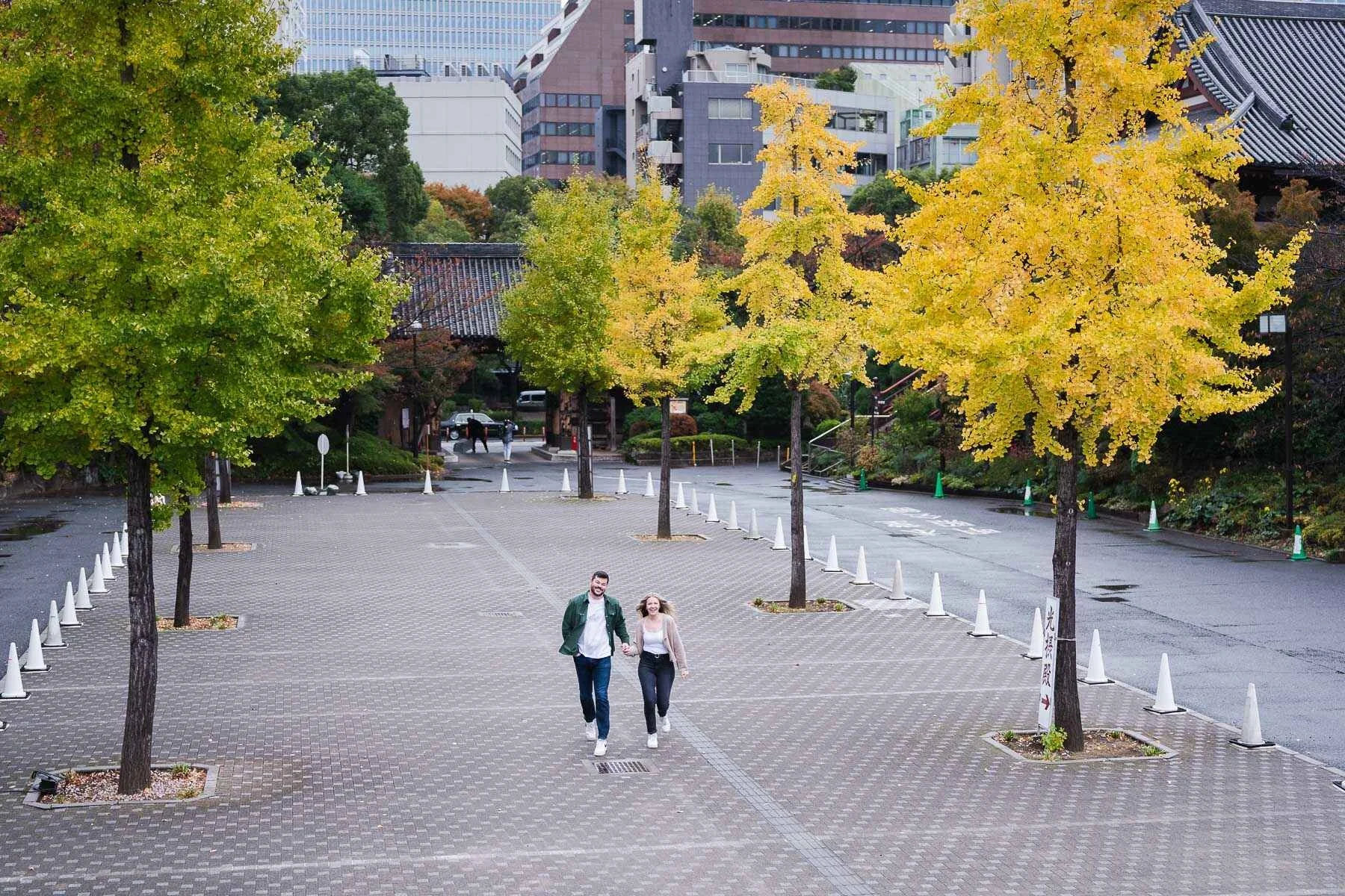 After the rain went away, the couple ran thru a lane of yellow-leave trees inside Zojoji Temple