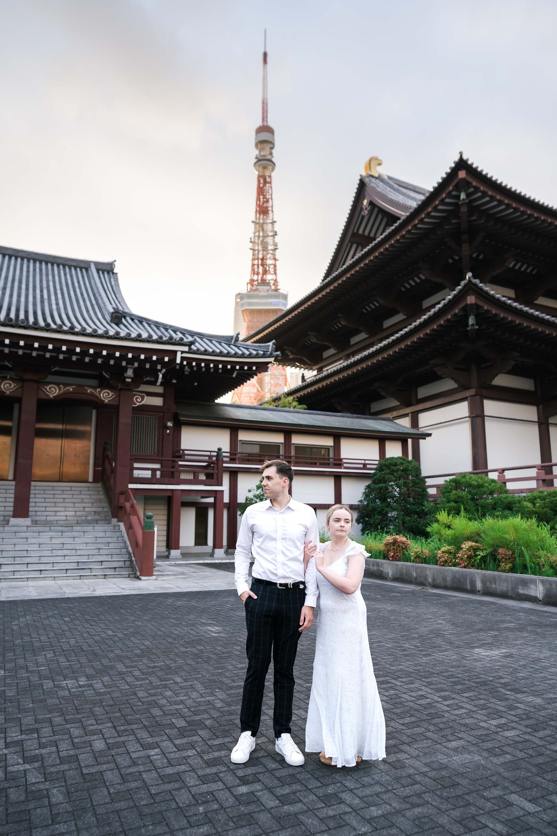Couple at Zojoji Temple ground with Tokyo Tower, Tokyo Japan