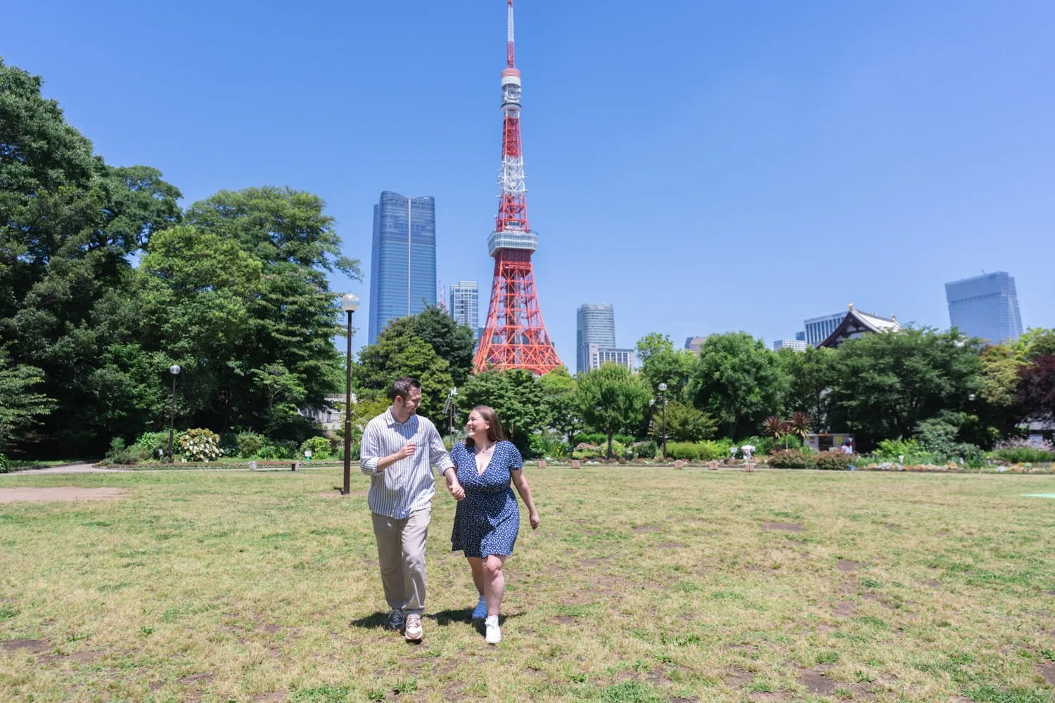 Rosie and Jack running in the park with Tokyo Tower in the background.