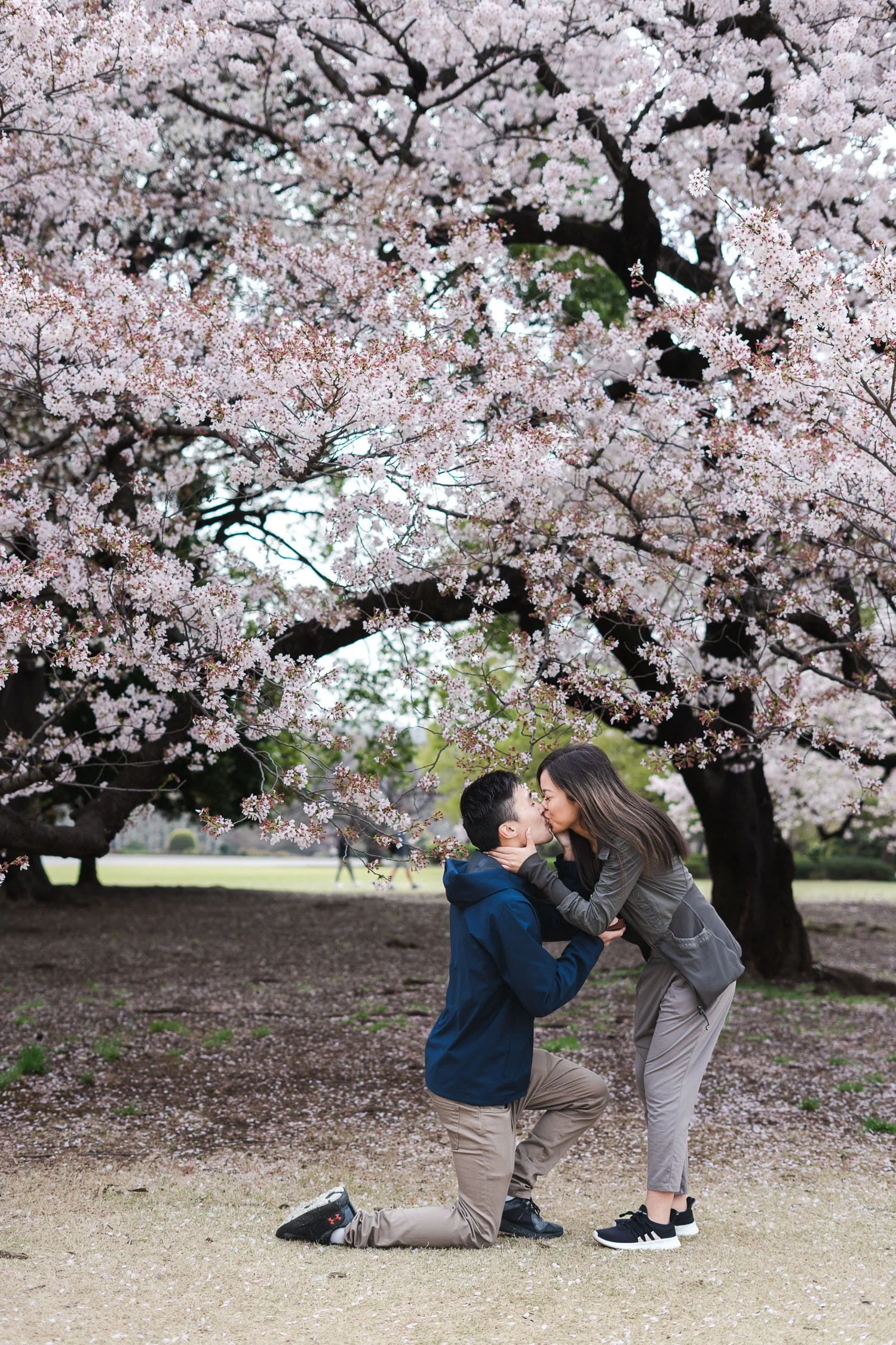 A couple kissing each other after she accepted his marriage proposal. Captured by Kanp Photography in Tokyo