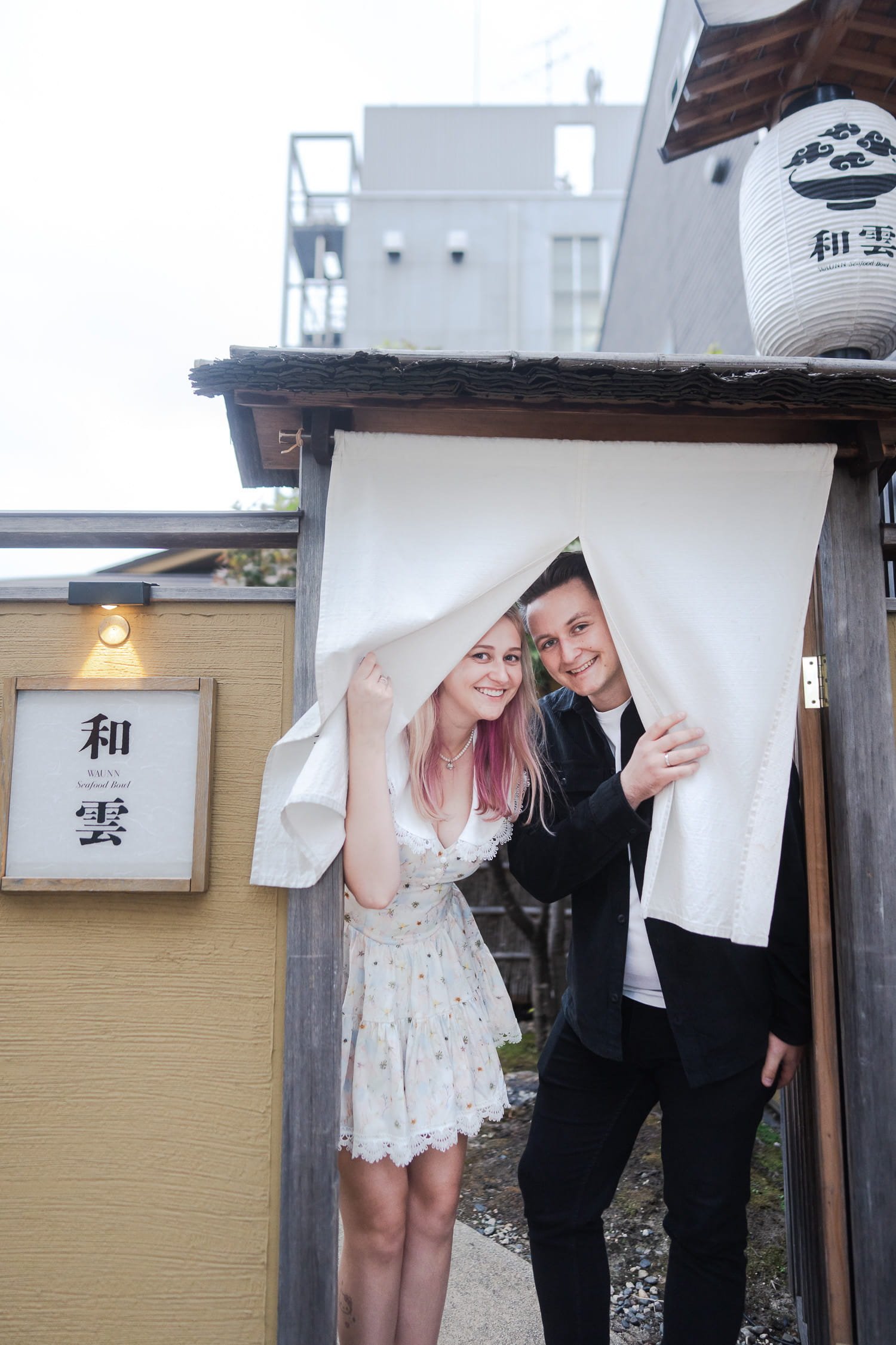 Migle and her husband posing in front of a Japanese restaurant in Asakusa