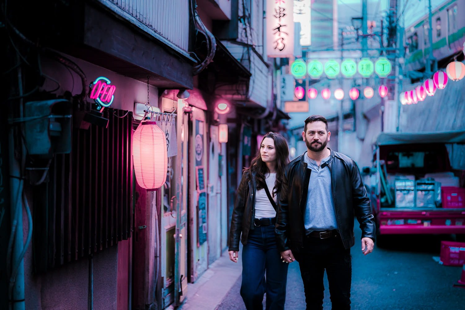 Couple walking through Nonbei Yokocho's lantern-lit alley in Shibuya, Tokyo, cyberpunk-style photoshoot