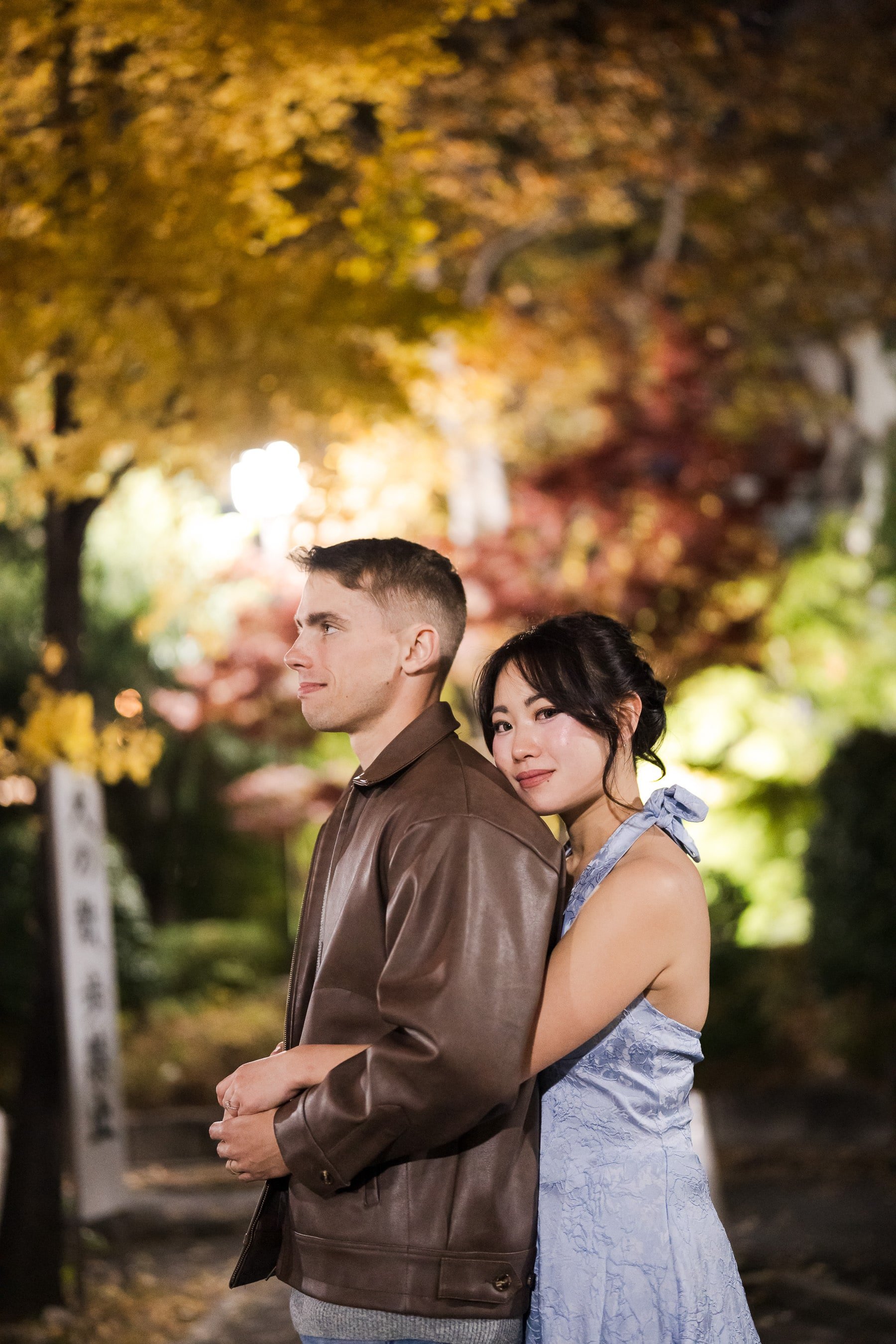 Night couple photoshoot at Shiba Park with colorful foliage leaves in the background