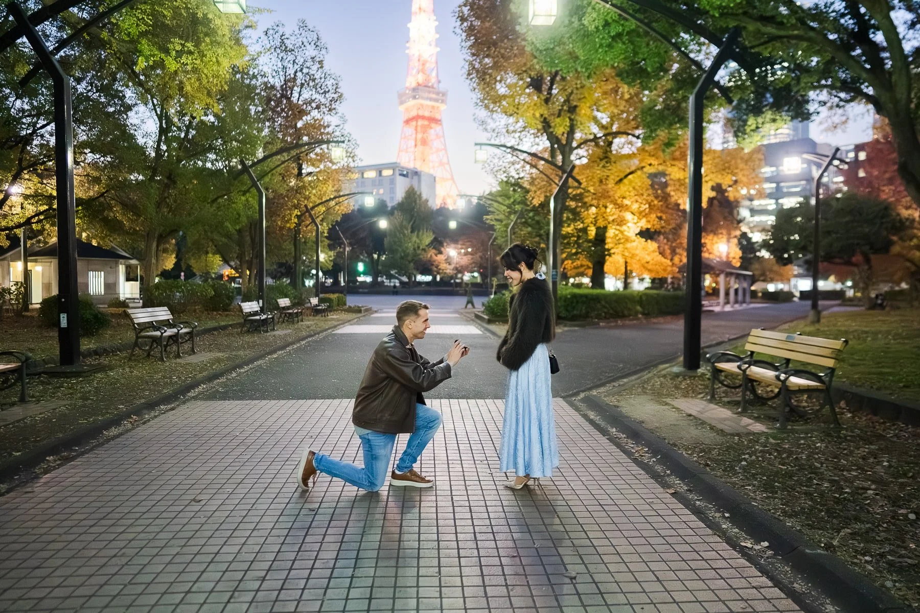 Surprise proposal at night in Shiba Park during autumn season with Tokyo Tower in the background
