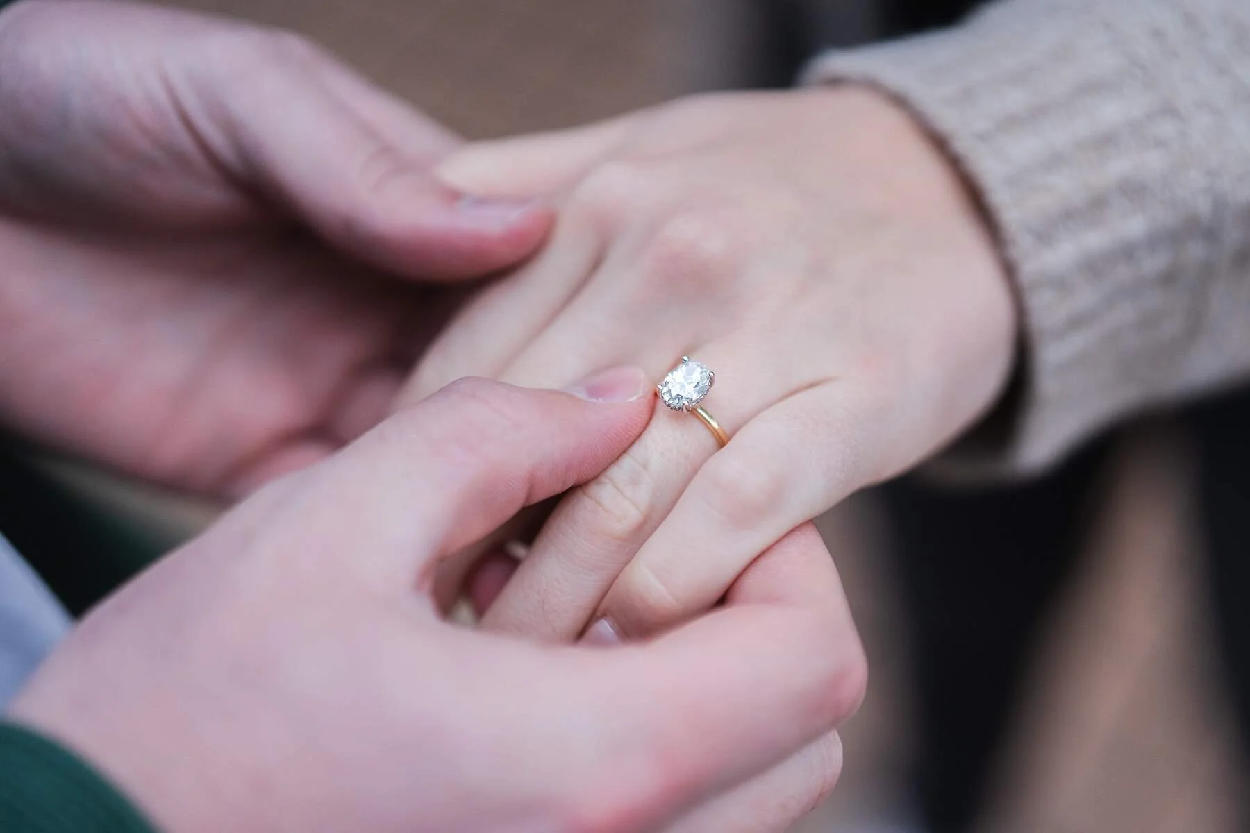 A zoom-in shot of the moment when he put the gorgeous diamond ring into her finger.