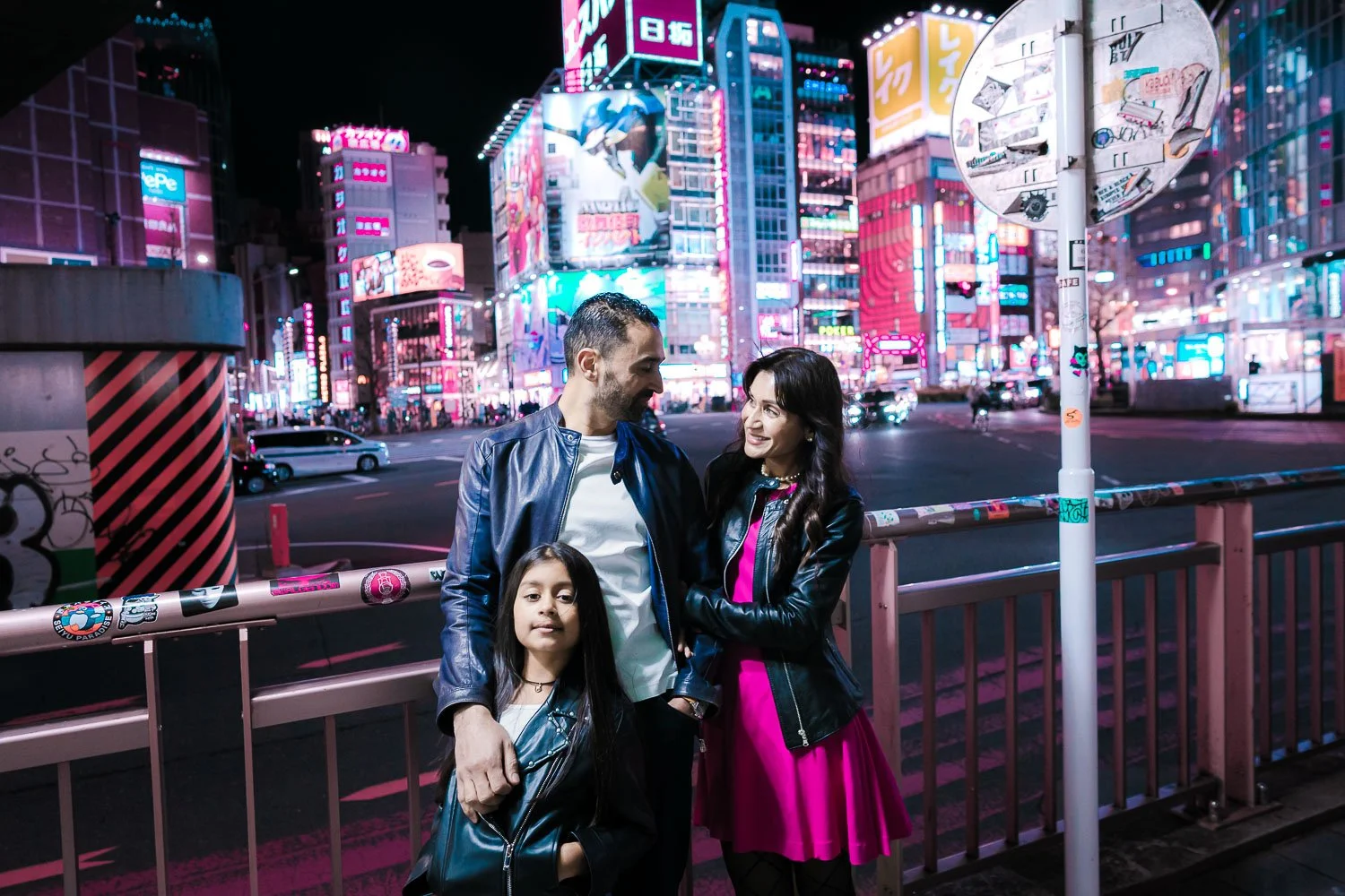 Family having a neon-lit photoshoot in Kabukicho, Shinjuku