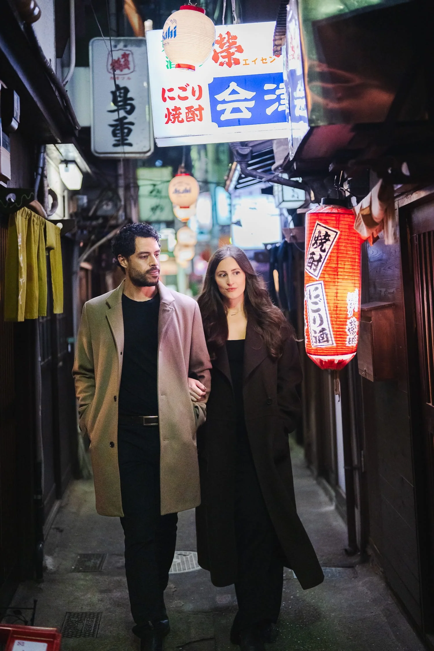 Another couple exploring a lantern alley in Shibuya Nombei Yokocho