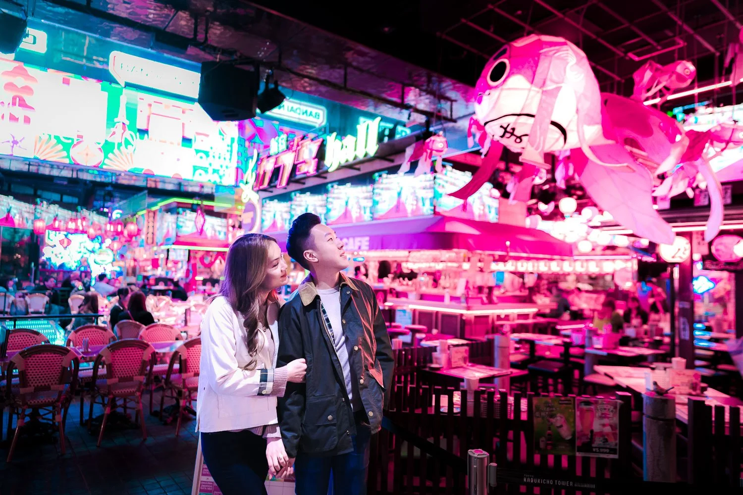 Couple in Kabukicho, Tokyo, beneath a neon koi lantern in a cyberpunk-style portrait session
