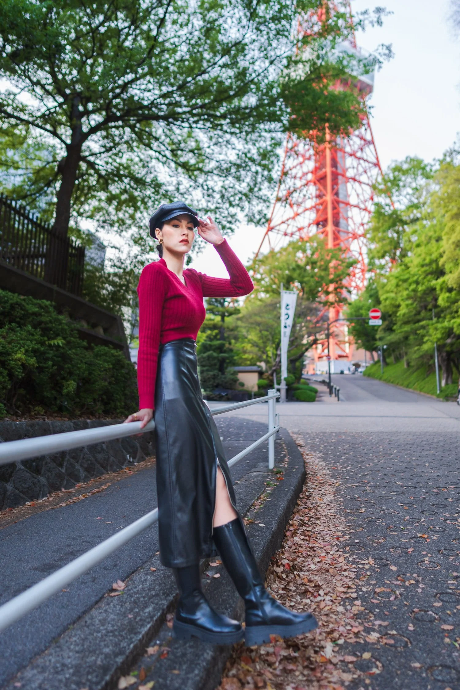 Female influencer poses in front of Tokyo Tower for a personal branding photoshoot