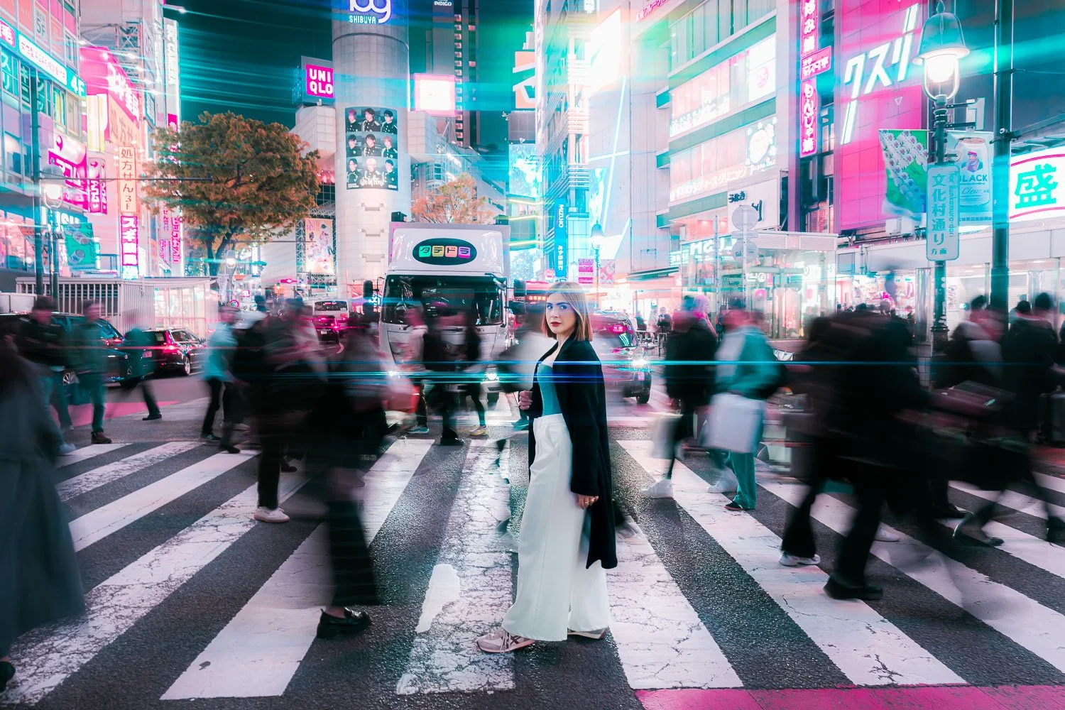 Solo female traveler standing still at Shibuya Crossing during cyberpunk photography experience.