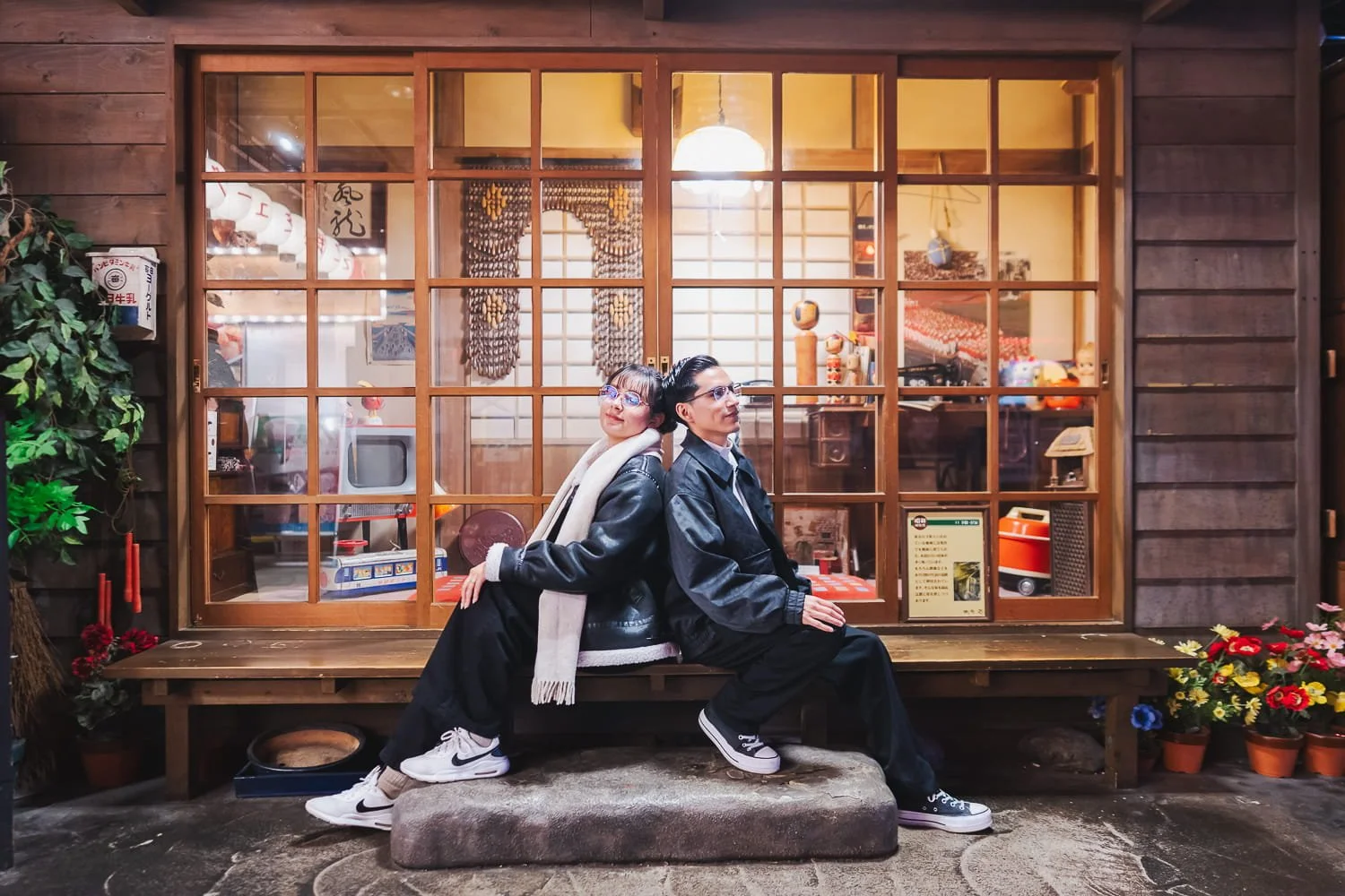 Couple sitting in front a traditional Japanese room during a post-engagement photoshoot in Odaiba