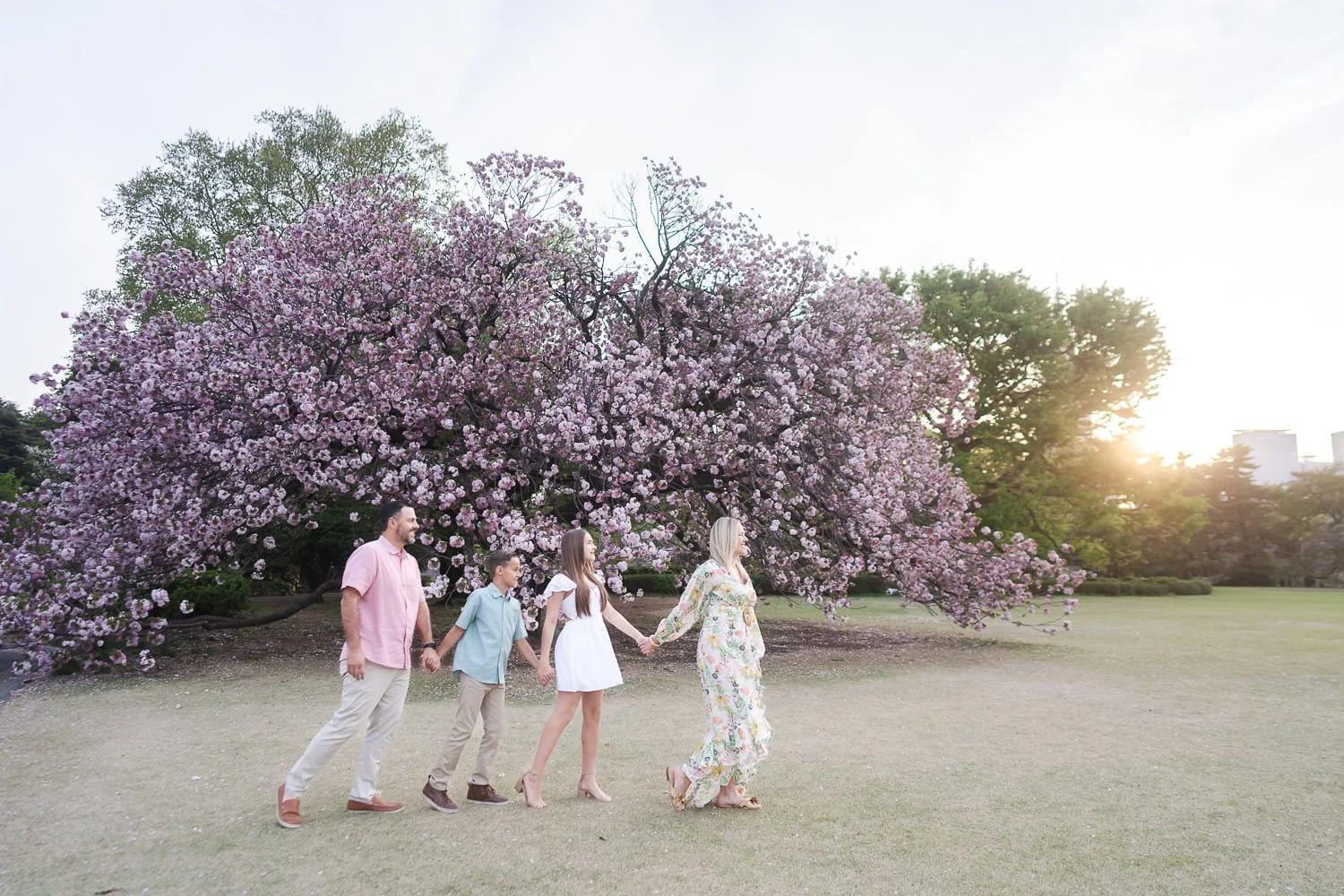 The family walking to exit after our family cherry blossom photoshoot comes to an end.