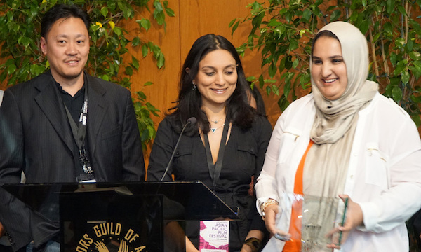 AS EXECUTIVE PRODUCER ALAN PAO AND PRODUCER MEGHA KADAKIA LOOK ON, DIRECTOR/CO-SCREENWRITER LENA KHAN ACCEPTS THE FESTIVAL GRAND JURY PRIZE FOR HER DEBUT FEATURE NARRATIVE "THE TIGER HUNTER" IN CEREMONIES PRECEDING FESTIVAL CLOSING NIGHT ON APRIL 28. (PHOTO: STEVEN LAM)