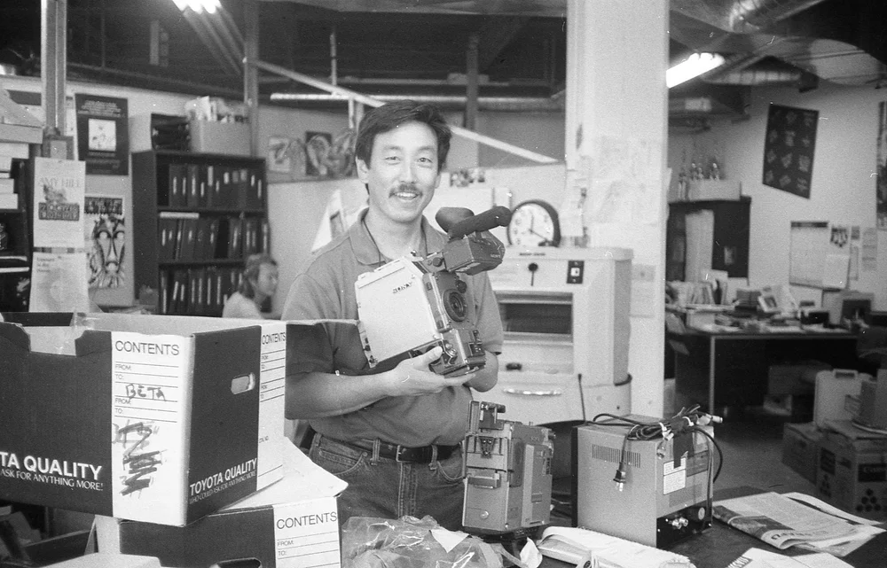 John Esaki Holds Camera