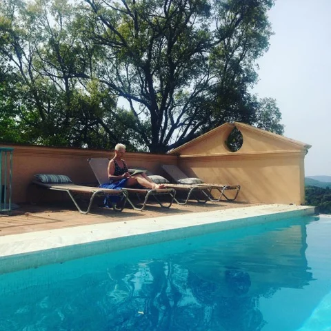 Jan painting by the pool