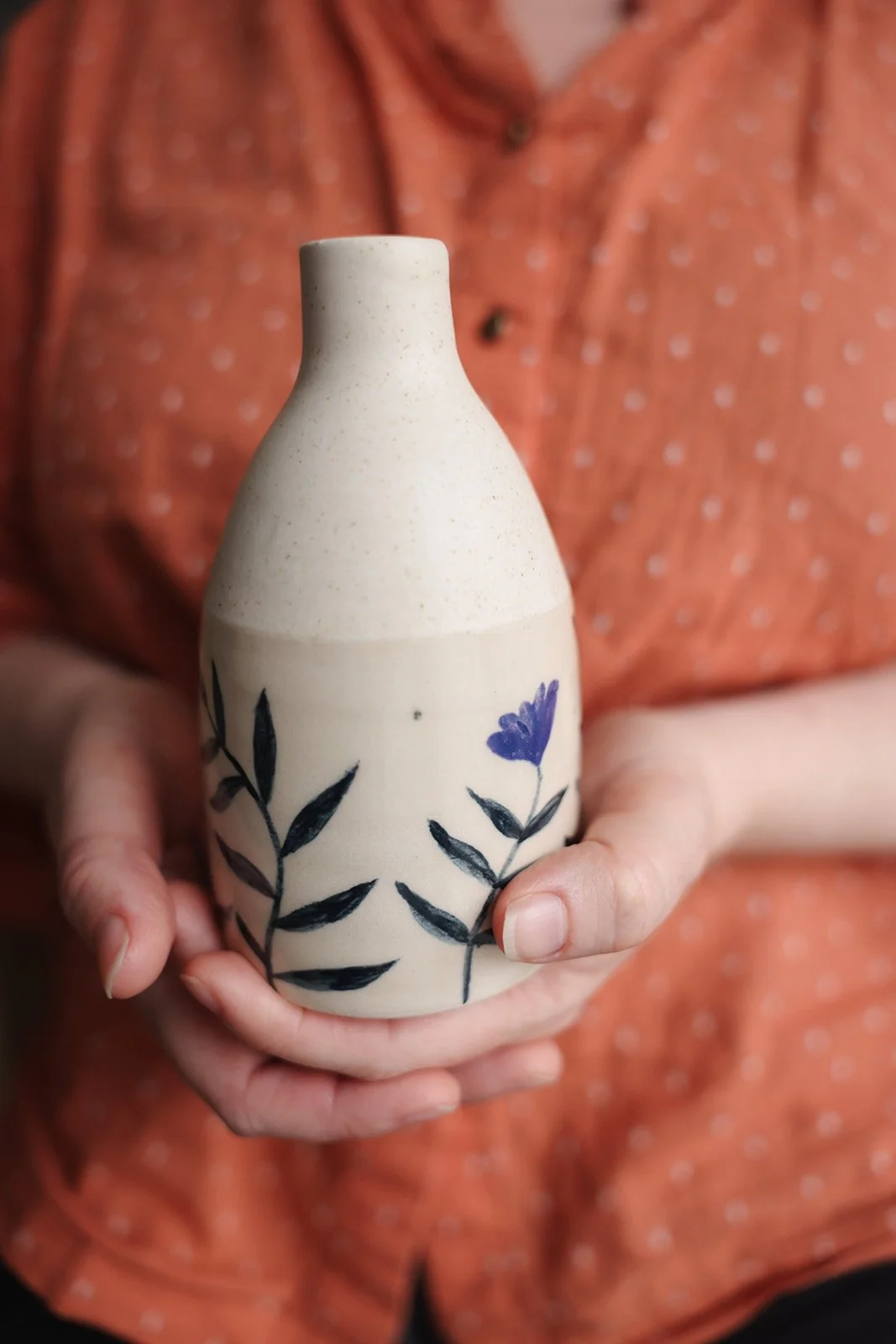 Wheel-thrown stoneware vase with handpainted botanicals.