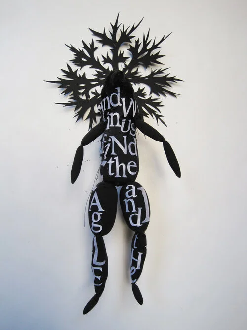 BLACK BIRD MAN PUPPET WITH WHITE LETTERS