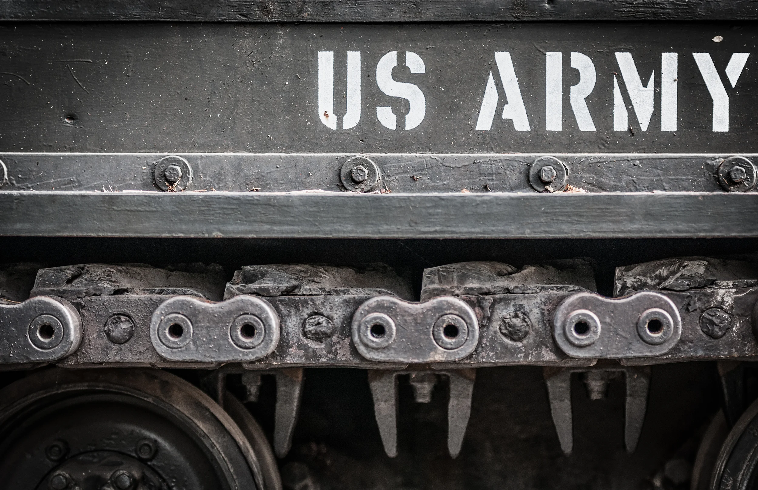 stock-photo-tank-close-up-with-wheel-caterpillar-and-text-us-army-on-it-focus-on-side-of-military-transport-139634210.jpg