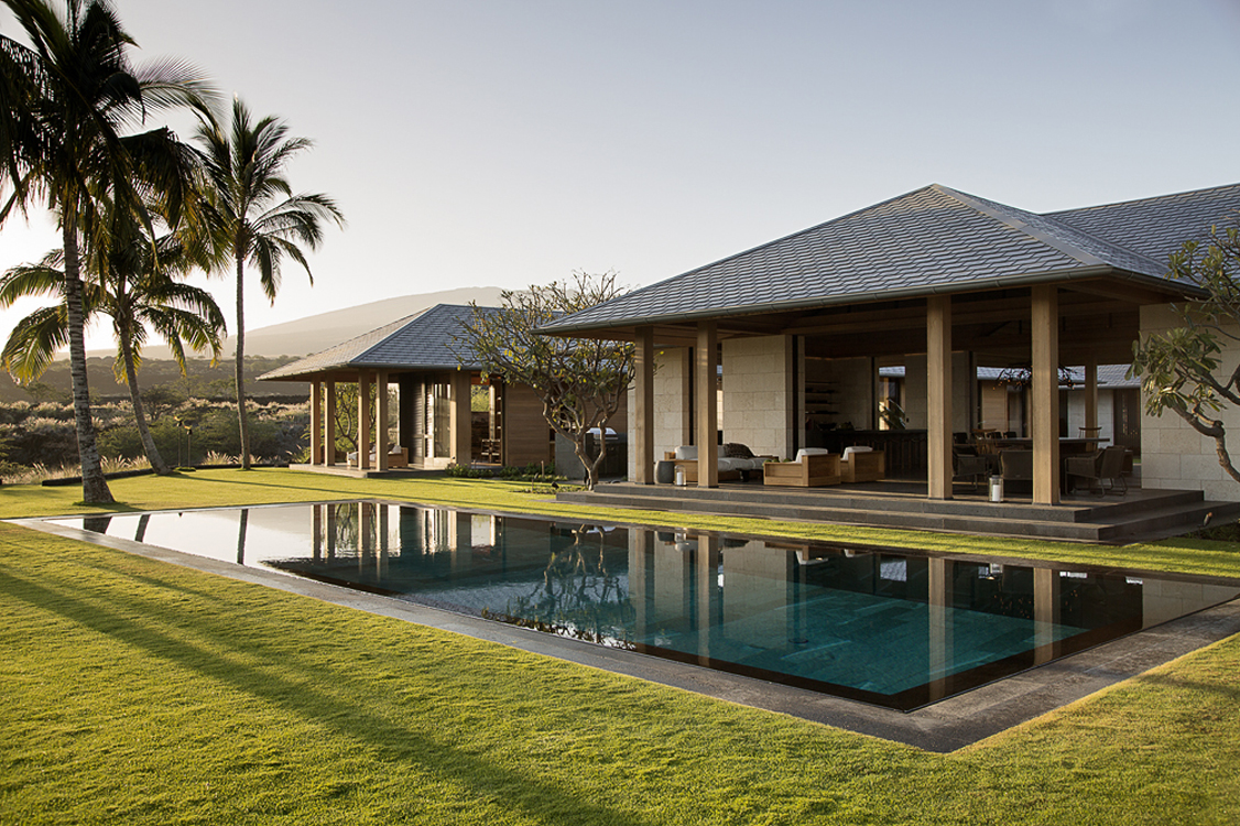The project is a modern interpretation of island style homes. Located on a lava flow, it both reflects and contrasts the surrounding landscape. Black lava rock is the primary building material and was used in several different ways in the garden. The surrounding landscape, including Kiawe trees and fountain grass, was brought into the site to frame the garden.