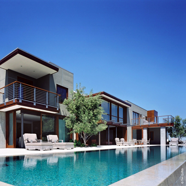 This project is located in Silicon Valley and is minimalist in nature. The home is situated on a steep slope focused towards expansive views. The pool acts as a retaining wall to hold the garden close to the level of the home. The garden contains ma