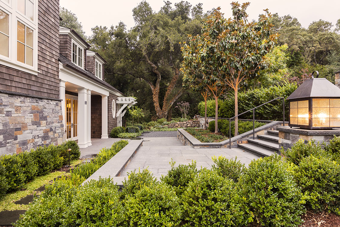 The garden has traditional bones with a contemporary twist. The entry garden includes a lion’s head fountain that spills into a hidden basin. The rear garden includes a plunge pool with a spa and wet shelf. The garden has a lush feeling while including drought tolerant plants. Both the front and rear gardens include custom light fixtures to add visual interest during the day and night.