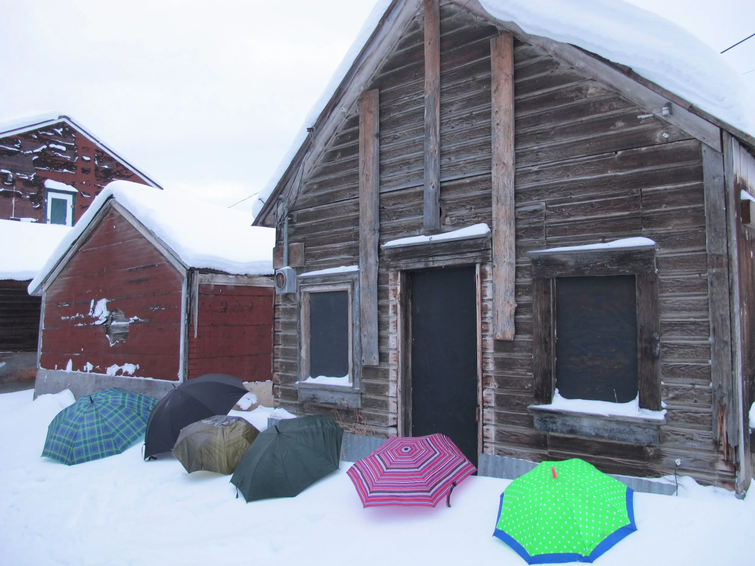 Umbrellas set up for casting with paper and ice (Dawson City, Yukon, back alley behind KIAC Klondike Institute of Art and Culture)