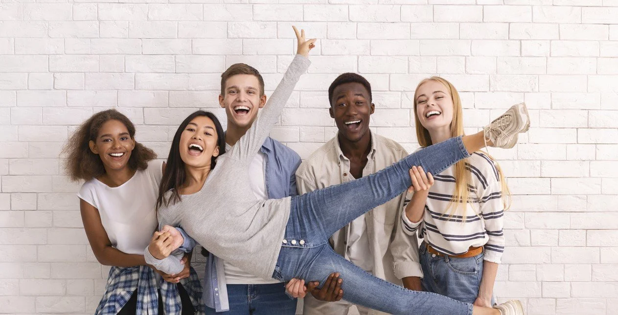 Joyful international group of students lifting asian girl up,.jpg