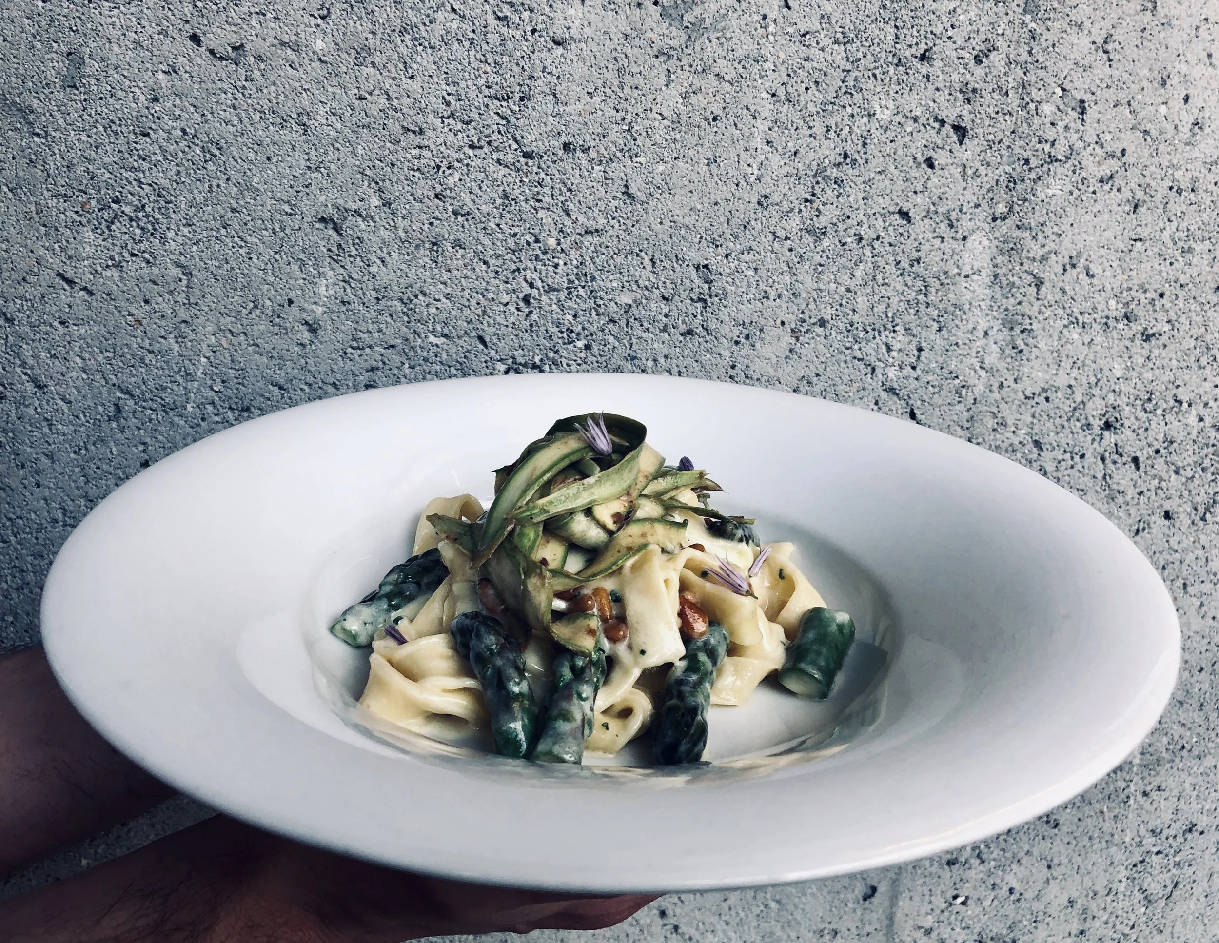Tagliatelle with asparagus, pine nut butter sauce, black garlic, and pecorino.