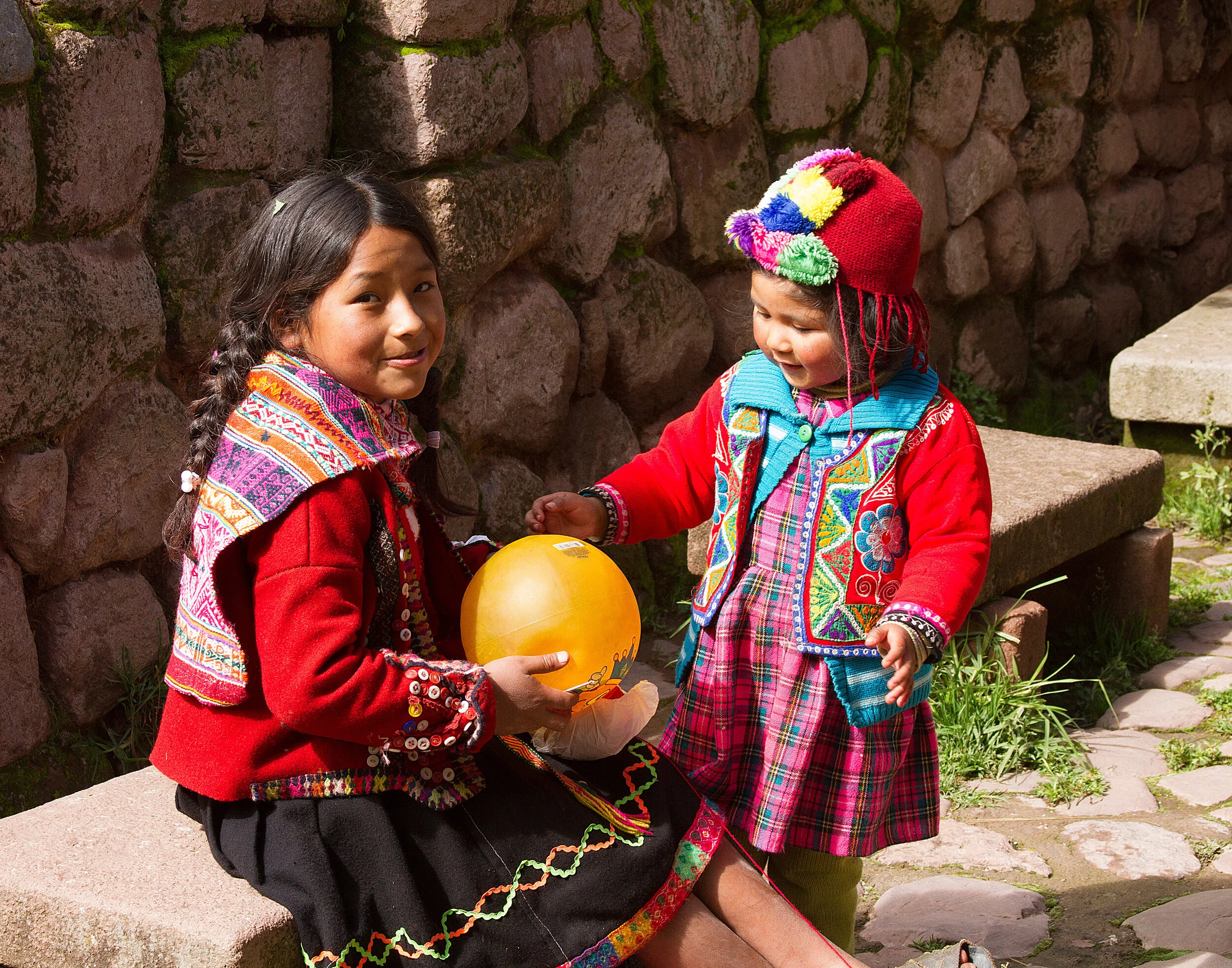 Girls playing ball on llama farm, Cusco, Peru 2016