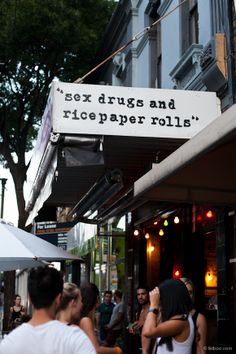 "sex drugs and rice paper rolls" sign above a restaurant 