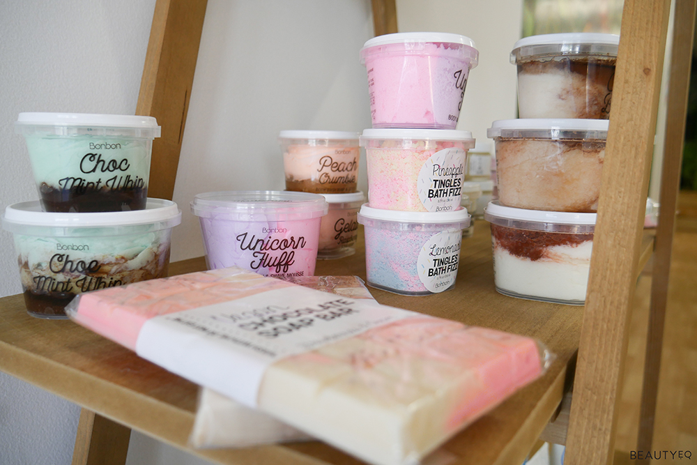 a range of beauty products on a wooden shelf
