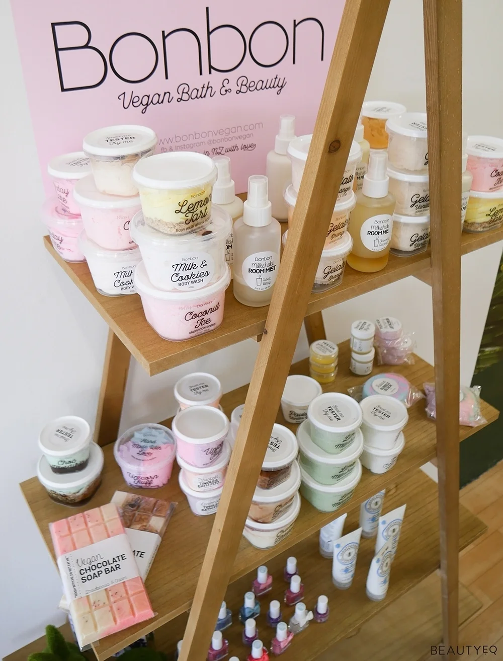 A range of different beauty products on triangular shaped wooden shelves