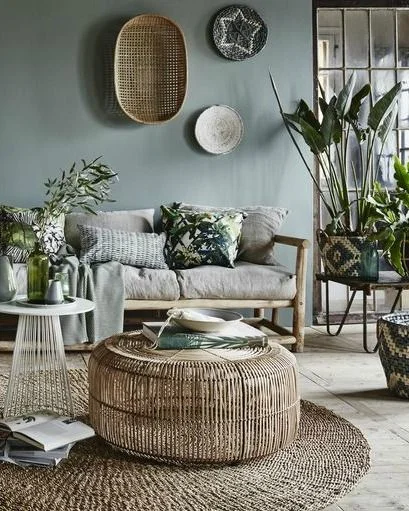 Modern living room with green walls and bamboo coffee table