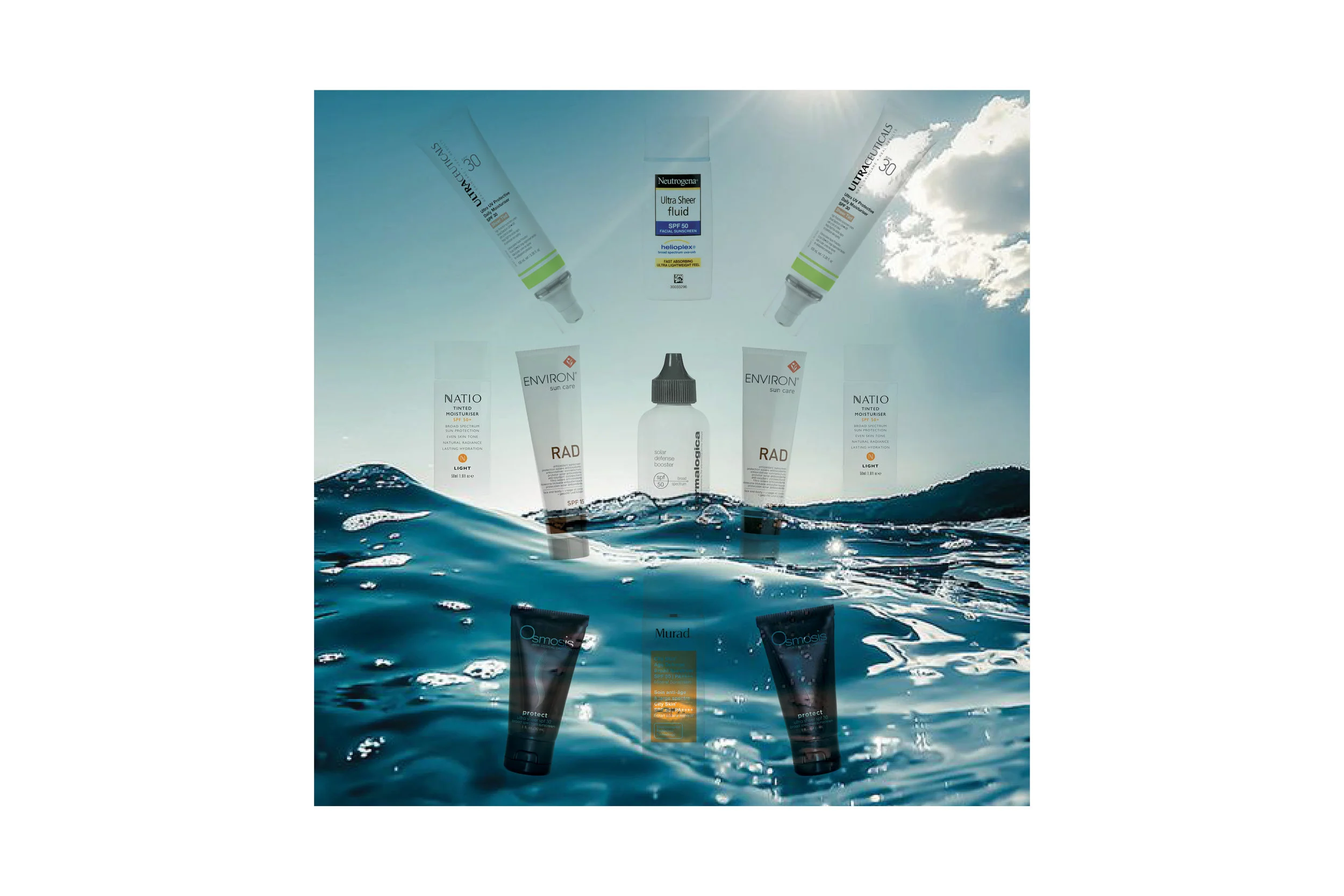 A range of different beauty products spread out against a background of a blue sea and sky 