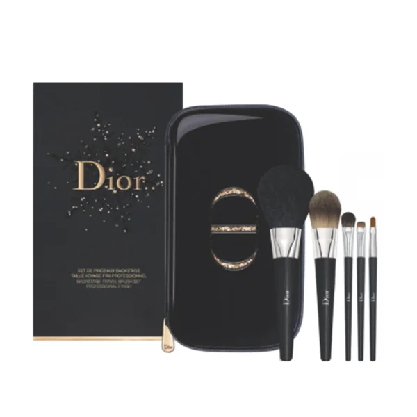 Dior makeup couture brush set with a range of different brushes lines up next to black and gold case and packaging 