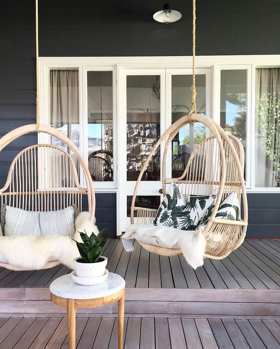 Outdoordeck space with hanging cane egg chairs