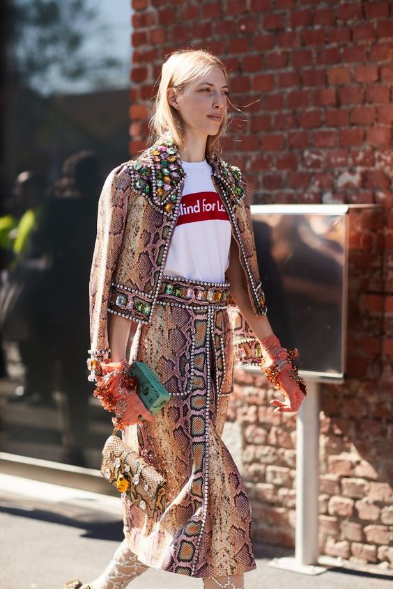 Blonde model wearing snake print blazer and skirt with white print t shirt