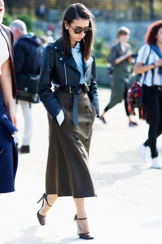 Brown hair model wearing leather jacket and leather skirt with black heels