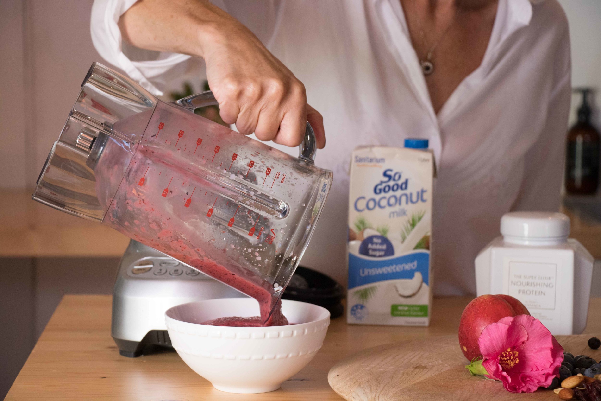 Woman making smoothie bowl 