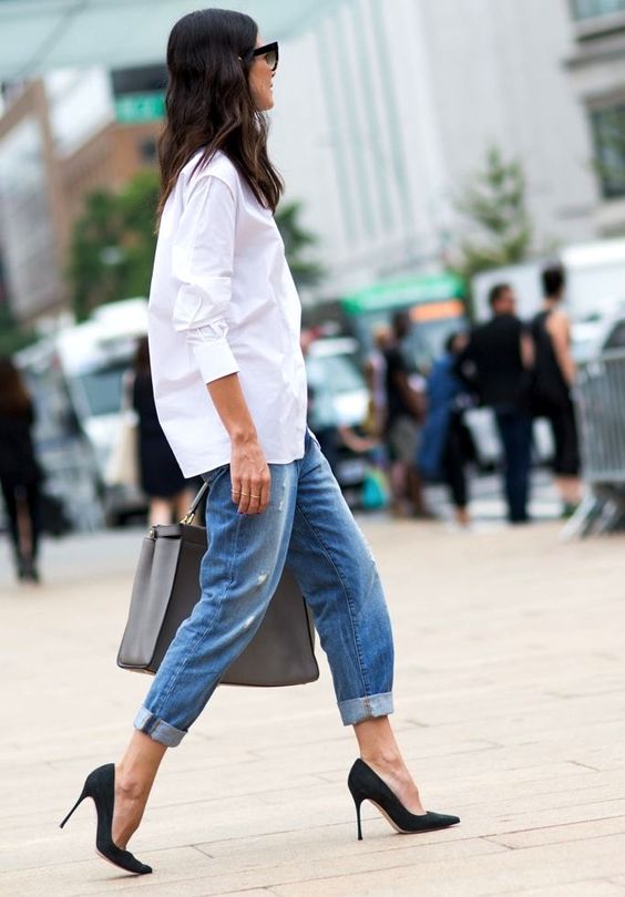 brown hair model with black sunglasses, white shirt, blue jeans and black heels